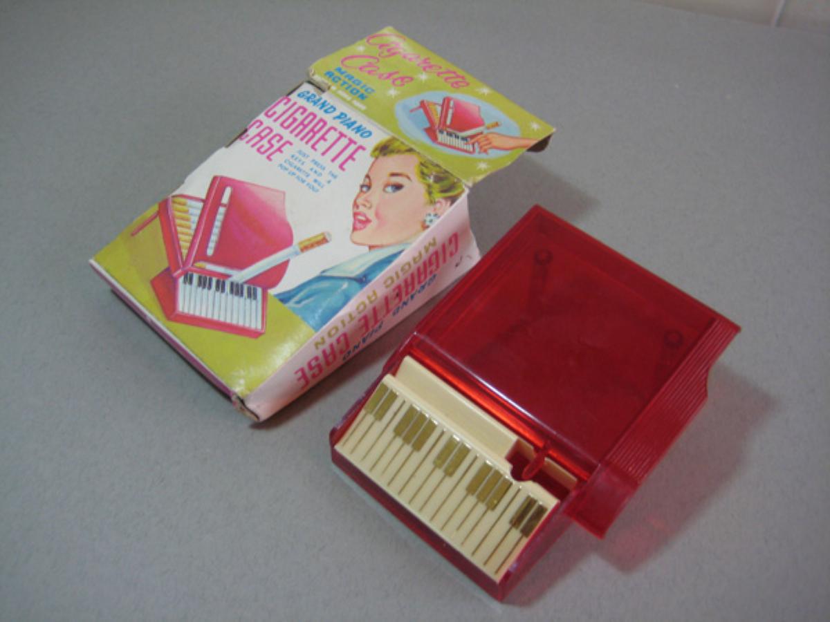 Red Lucite piano shaped cigarette box