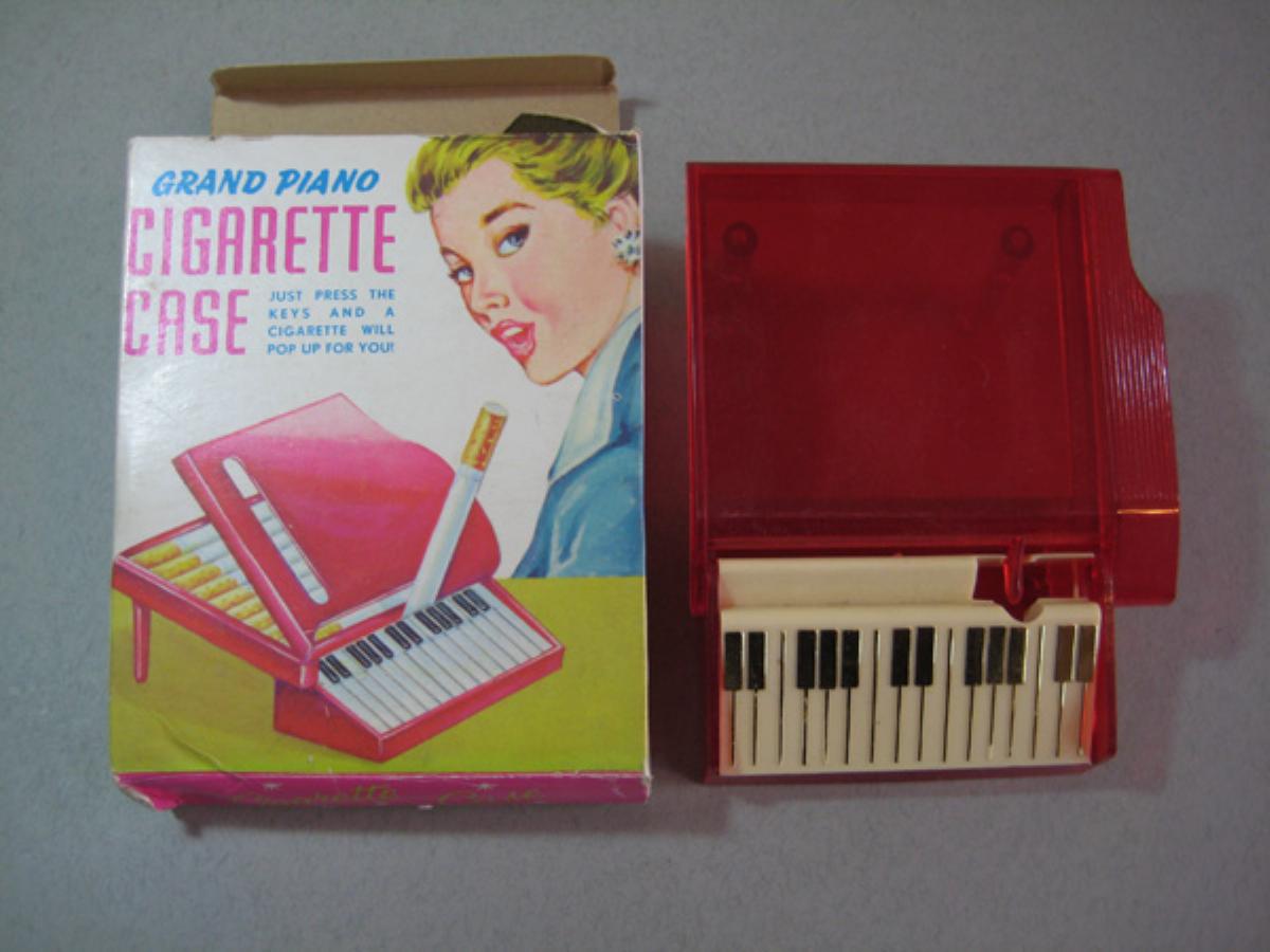 Red Lucite piano shaped cigarette box